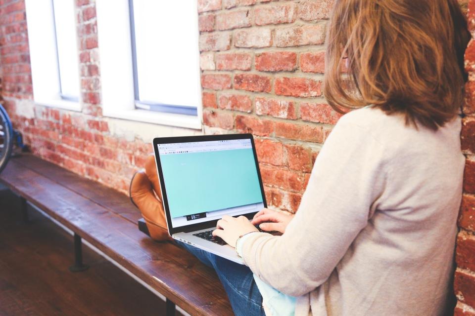 Two professionals discussing consumer research on a laptop